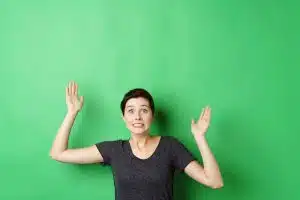 Confused or disappointed woman with hands up