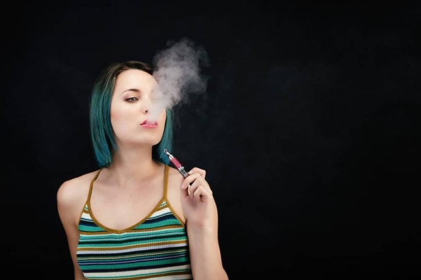 woman vaping marijuana pen