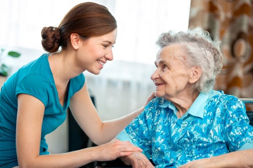 Senior woman with her caregiver at home