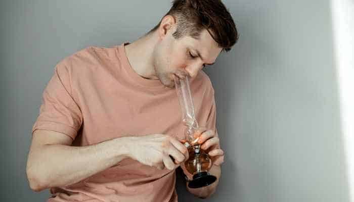 man smoking a bong